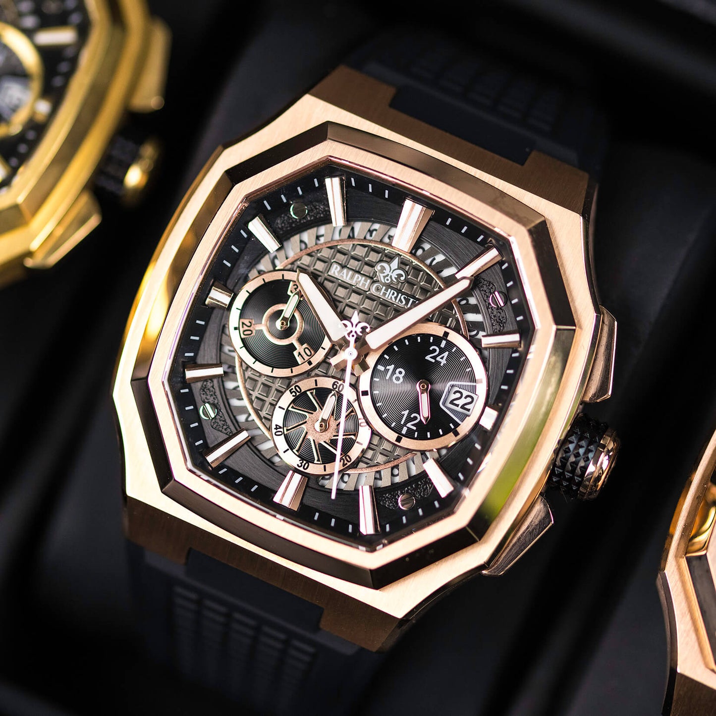 Luxury watch with rose gold and black design on a dark background